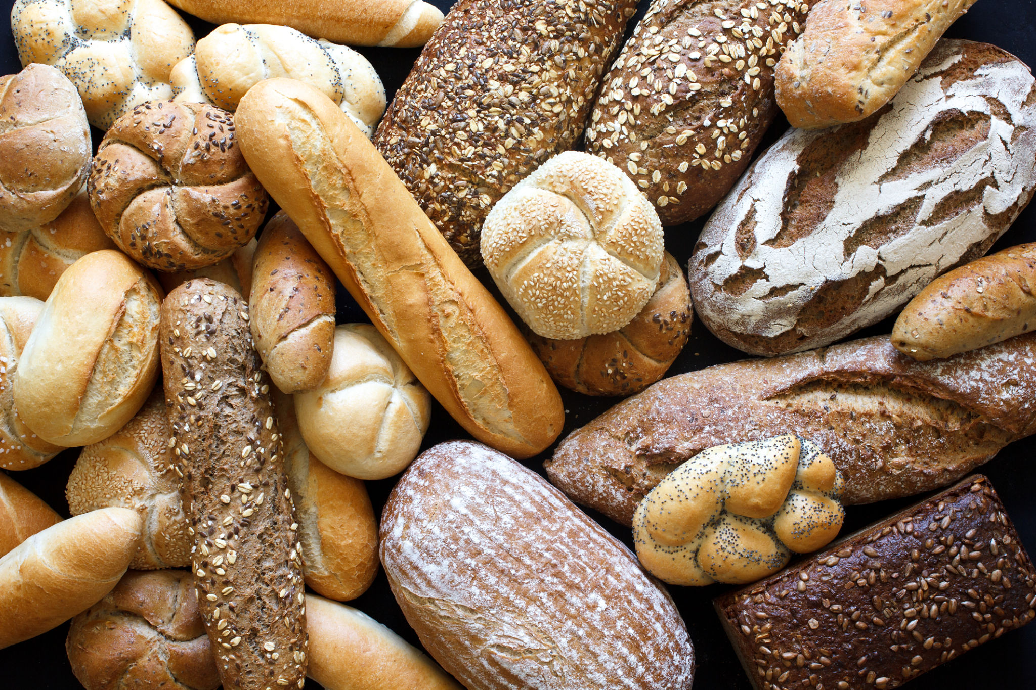 Many mixed breads and rolls shot from above