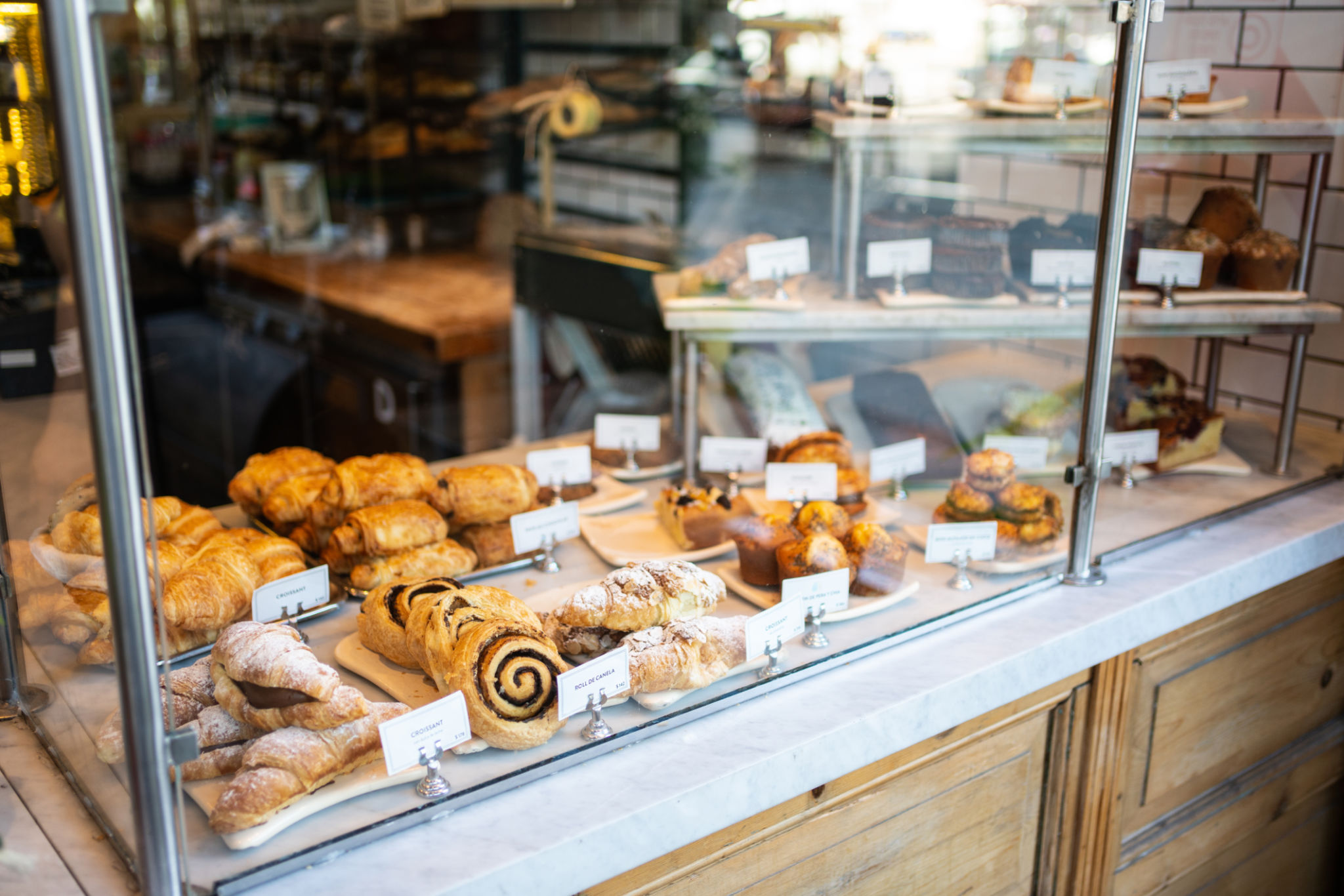 Various baked food in glass cabinet at bakery